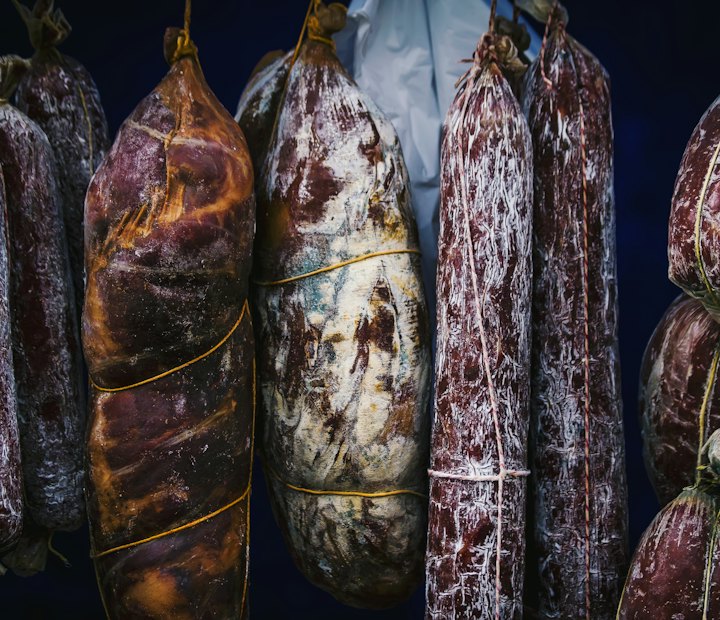 Luftgetrocknete italienische Salami, nebeneinander aufgehängt